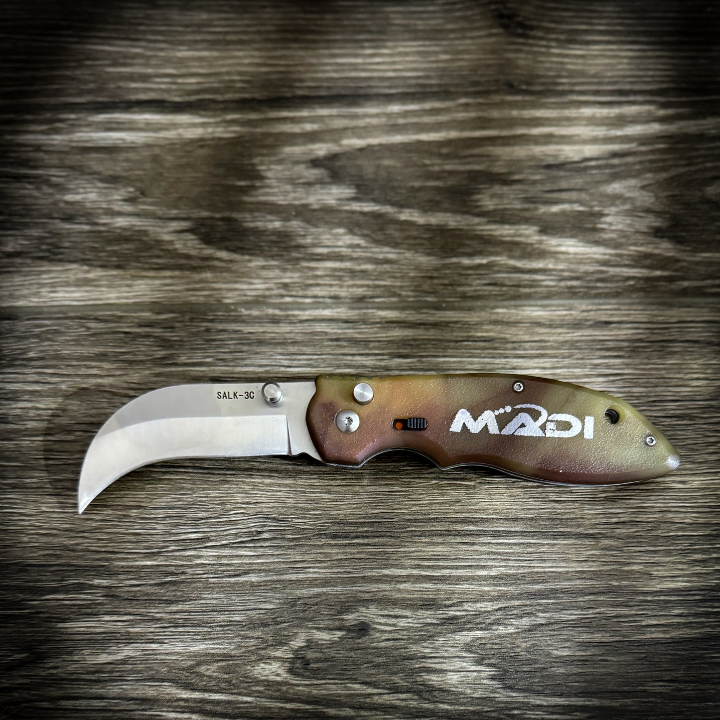 Madi Spring Assisted Knife with belt clip and stainless steel blade, ideal for linemen and blue-collar workers