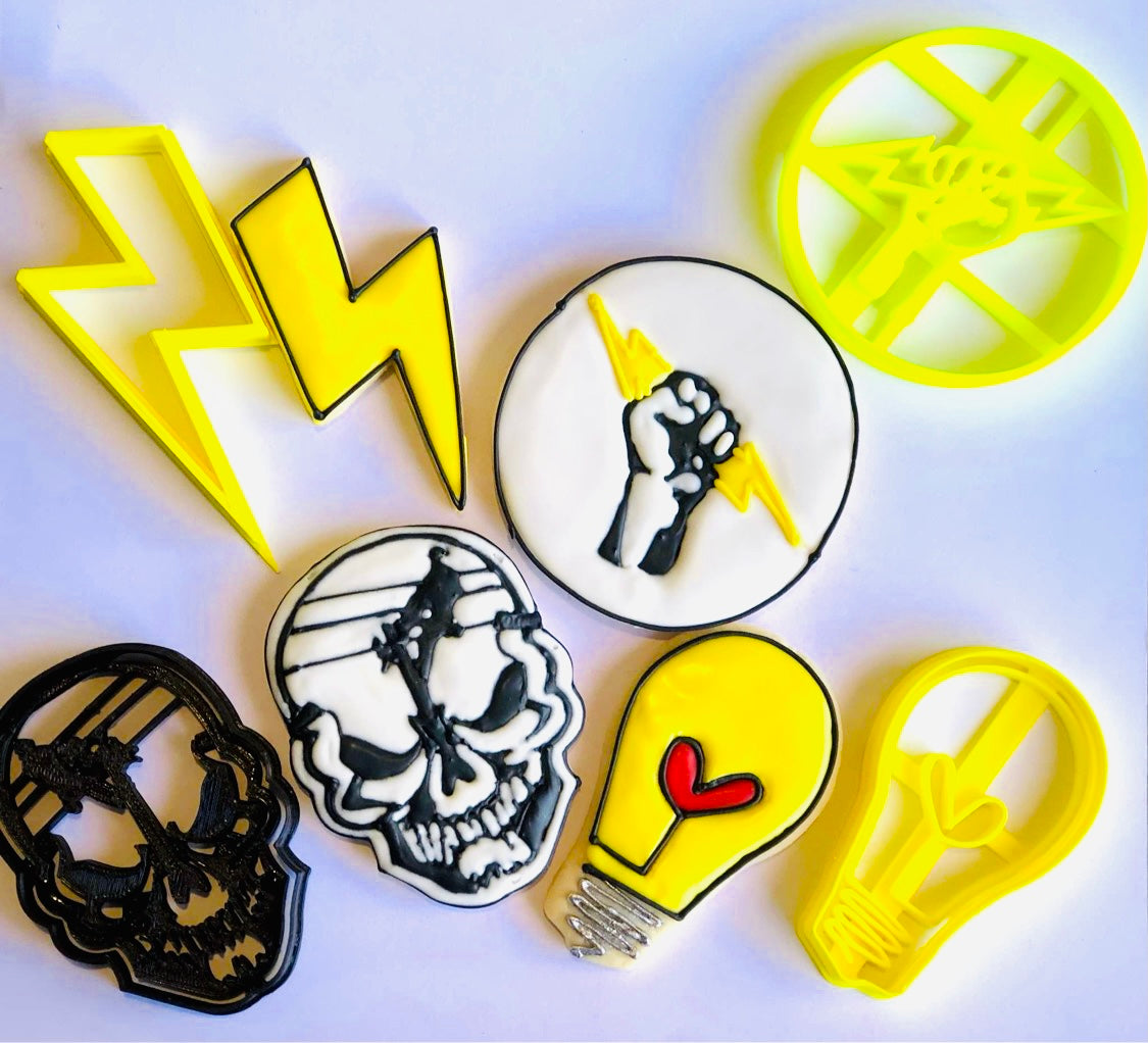 Lineman skull, lightbulb, lightning bolt, and fist icing examples next to cookie cutter set