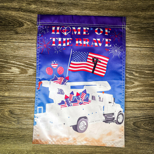 "Home Of The Brave" double-sided garden flag displayed against a wooden background, showcasing a patriotic design with American imagery.