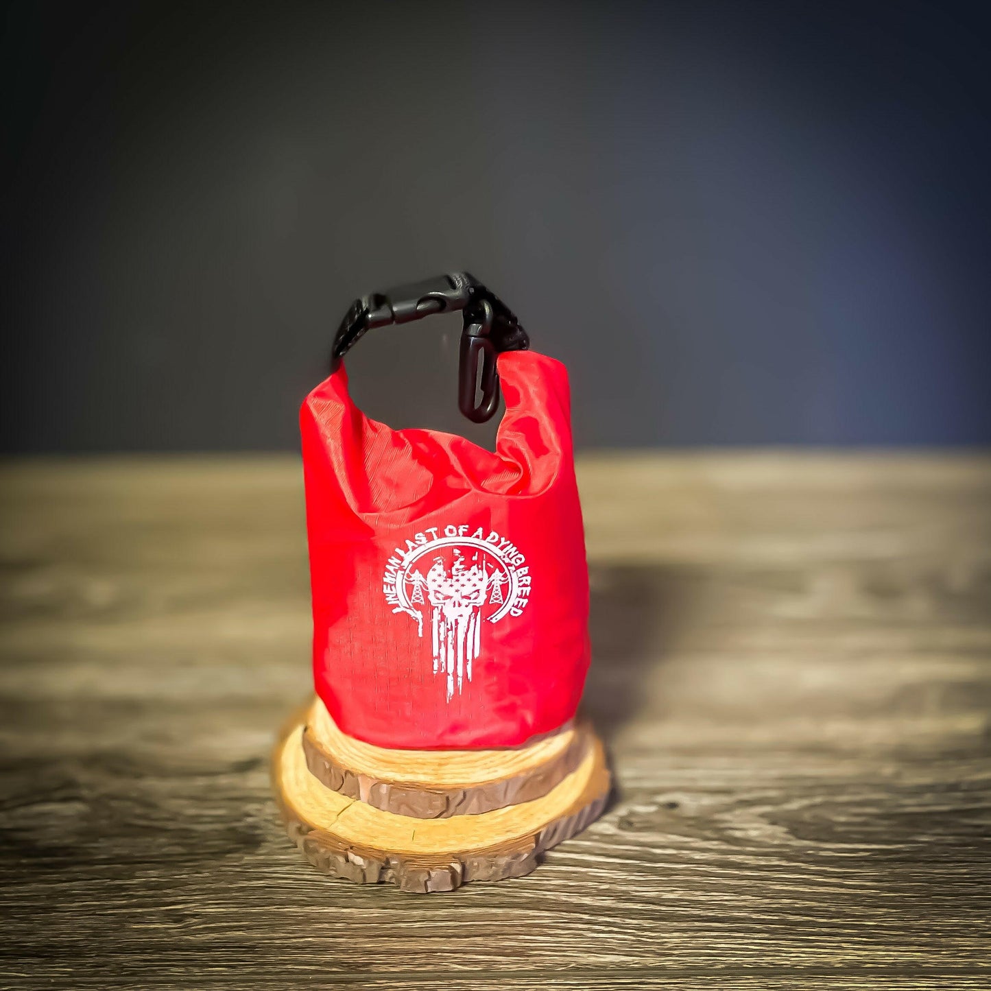 Red LineMan First Aid Kit with 'Last of a Dying Breed' white imprint on waterproof roll-top bag