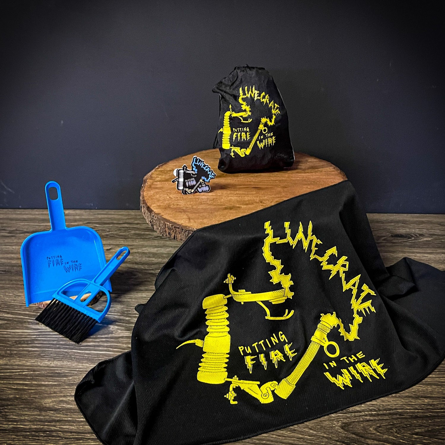 LineCrate 'Putting Fire in the Wire' Utility Set with dustpan, broom, cooling towel, hammock, and sticker in yellow and black.