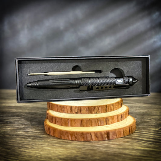 Tactical pen with glass breaker and extra ink cartridge in a foam-lined box, ideal for blue-collar tradesmen and patriots