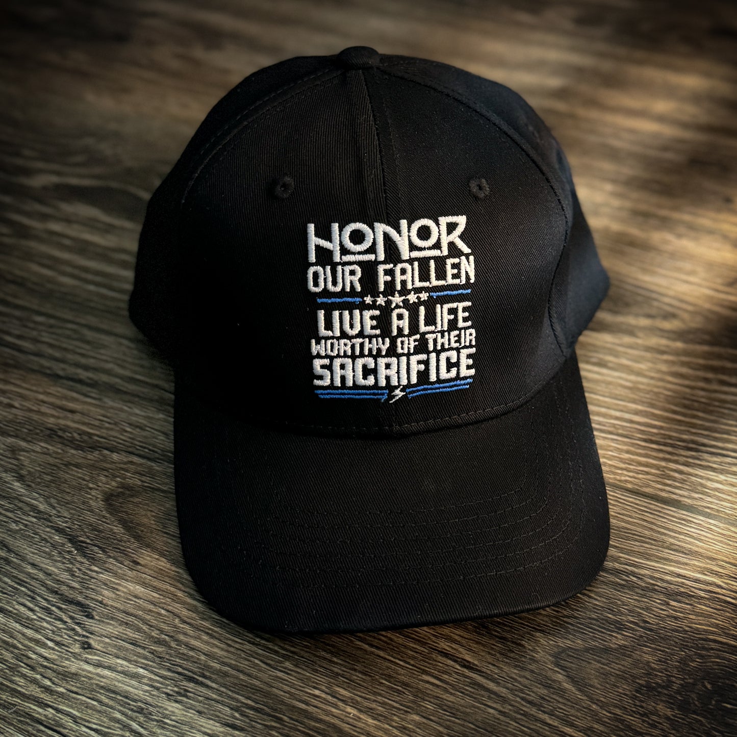 Black hat with 'Honor Our Fallen, Live a Life Worthy of Their Sacrifice' embroidered in white and blue text, designed to honor our fallen