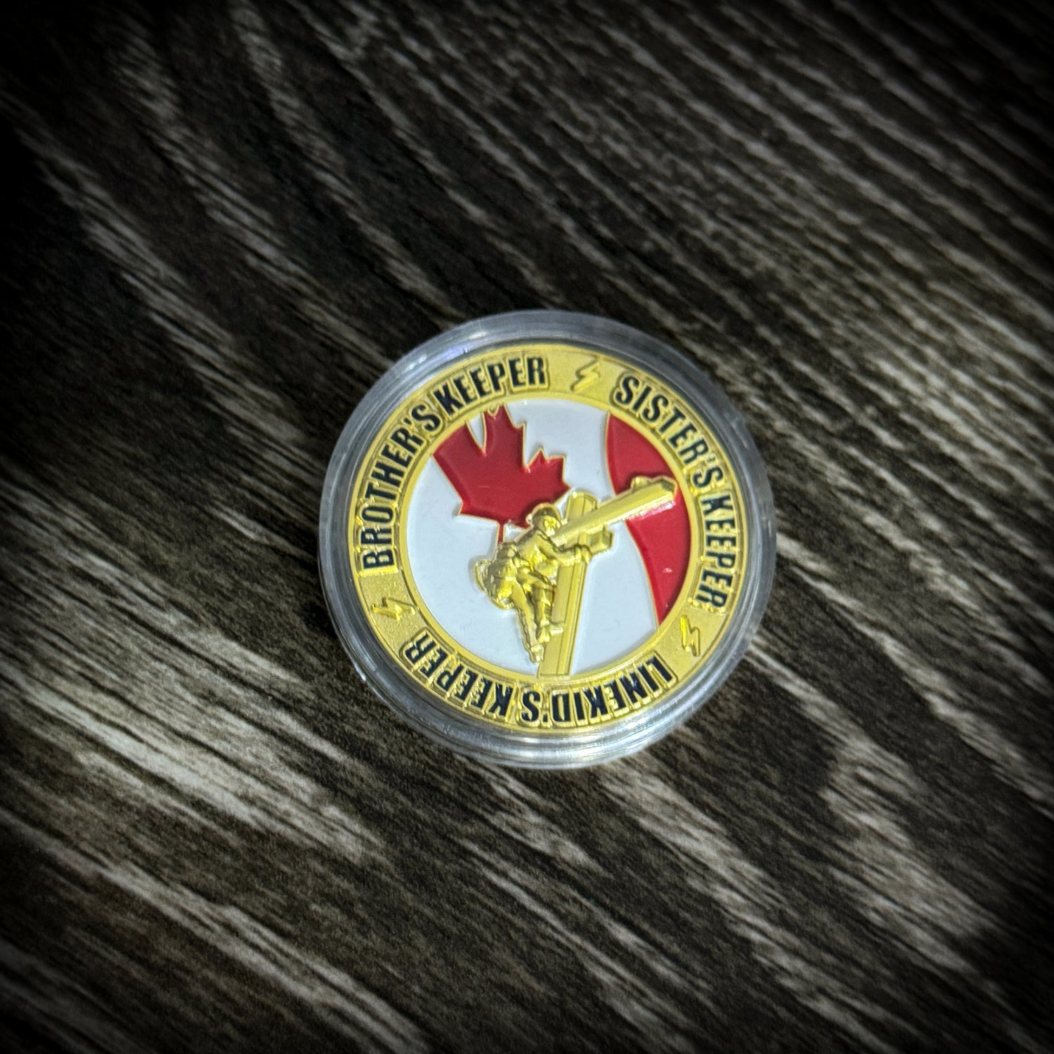 LineMan Brotherhood Challenge Coin featuring a skull, crossbones, and Canadian maple leaf.