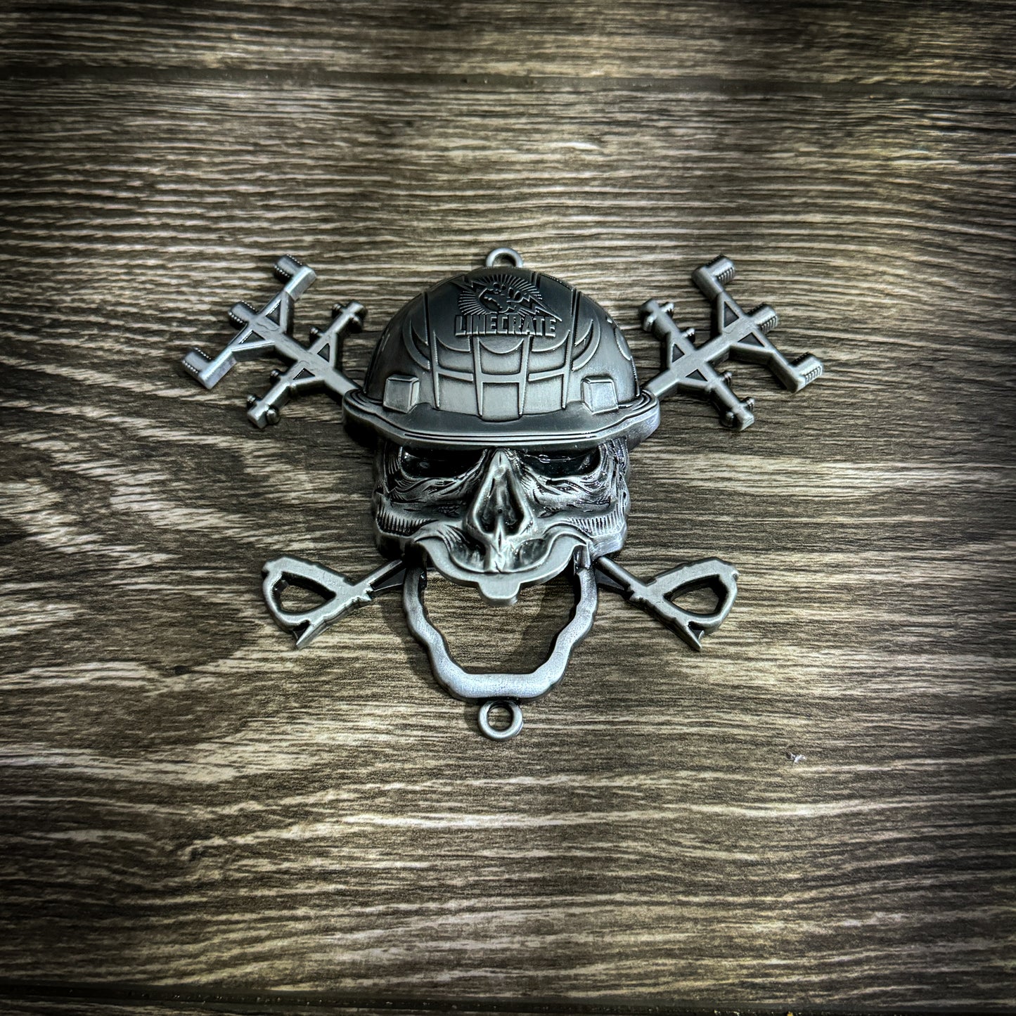 LineMan wall-mounted bottle opener with a skull and crossed power poles design.