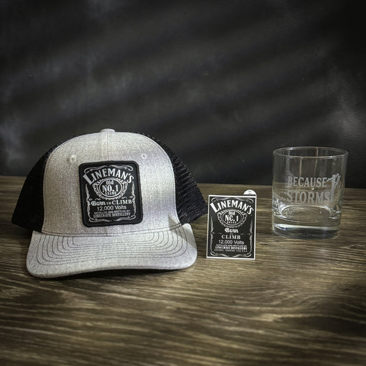 Born to Climb hat, sticker, and whiskey glass displayed together.