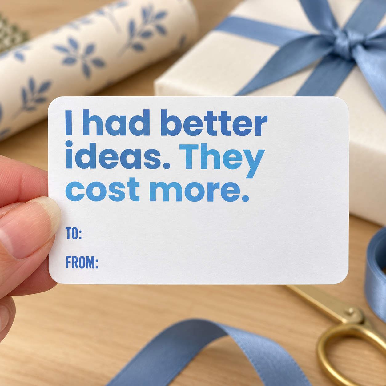 Close-up of I had better ideas gift sticker showing blue lettering and blank To and From fields
