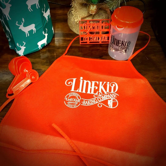 LineKid Baking Co Set with child size apron, measuring cup and spoons, and LineKid baking co cookie cutter
